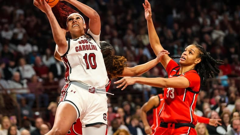 Feb 18, 2024; Columbia, South Carolina, USA; South Carolina Gamecocks center Kamilla Cardoso (10) shoots over Georgia Lady Bulldogs forward Destiny Thomas (33) in the first half at Colonial Life Arena. Mandatory Credit: Jeff Blake-USA TODAY Sports