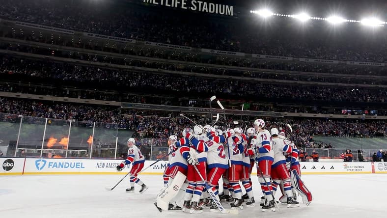 Feb 18, 2024; East Rutherford, New Jersey, USA; New York Rangers players celebrate after defeating the New York Islanders during the overtime period of a Stadium Series ice hockey game at MetLife Stadium. Mandatory Credit: Brad Penner-USA TODAY Sports