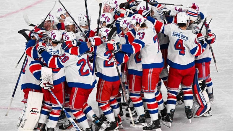Feb 18, 2024; East Rutherford, New Jersey, USA; The New York Rangers celebrate the 6-5 victory over the the New York Islanders after the game in a Stadium Series ice hockey game at MetLife Stadium. Mandatory Credit: Dennis Schneidler-USA TODAY Sports