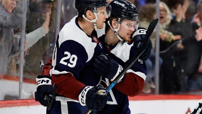 Feb 18, 2024; Denver, Colorado, USA; Colorado Avalanche center Nathan MacKinnon (29) celebrates his goal with defenseman Bowen Byram (4) in the second period against the Arizona Coyotes at Ball Arena. Mandatory Credit: Isaiah J. Downing-USA TODAY Sports