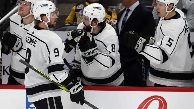 Feb 18, 2024; Pittsburgh, Pennsylvania, USA; Los Angeles Kings right wing Adrian Kempe (9) celebrates with the Kings bench after scoring the game winning goal against the Pittsburgh Penguins during the third period at PPG Paints Arena. Los Angeles won 2-1. Mandatory Credit: Charles LeClaire-USA TODAY Sports