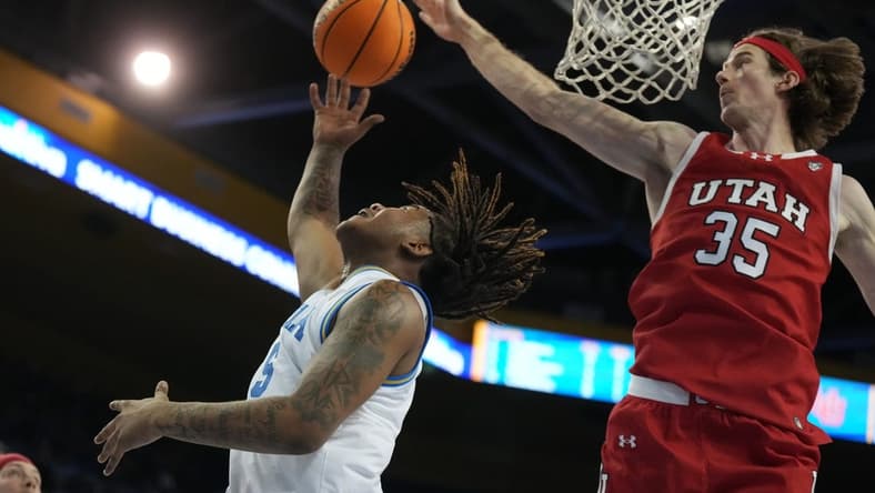 Feb 18, 2024; Los Angeles, California, USA; UCLA Bruins guard Brandon Williams (5) shoots the ball against Utah Utes center Branden Carlson (35) in the second half at Pauley Pavilion presented by Wescom. Utah defeated UCLA 70-69. Mandatory Credit: Kirby Lee-USA TODAY Sports