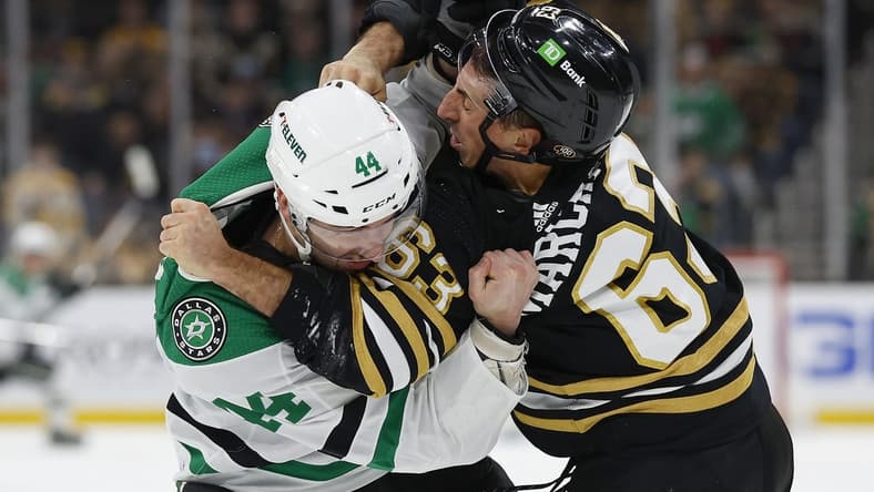 Feb 19, 2024; Boston, Massachusetts, USA; Dallas Stars defenseman Joel Hanley (44) fights with Boston Bruins left wing Brad Marchand (63) during the first period at TD Garden. Mandatory Credit: Winslow Townson-USA TODAY Sports
