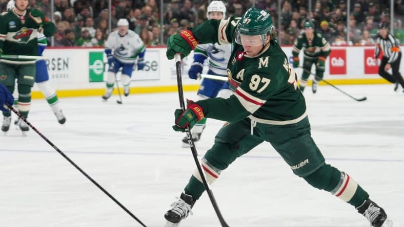 Feb 19, 2024; Saint Paul, Minnesota, USA; Minnesota Wild left wing Kirill Kaprizov (97) shoots against the Vancouver Canucks in the second period at Xcel Energy Center. Mandatory Credit: Matt Blewett-USA TODAY Sports