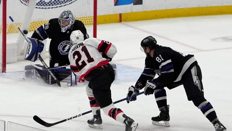 Feb 19, 2024; Tampa, Florida, USA; Ottawa Senators right wing Mathieu Joseph (21) scores against Tampa Bay Lightning goaltender Andrei Vasilevskiy (88) during the first period at Amalie Arena. Mandatory Credit: Dave Nelson-USA TODAY Sports