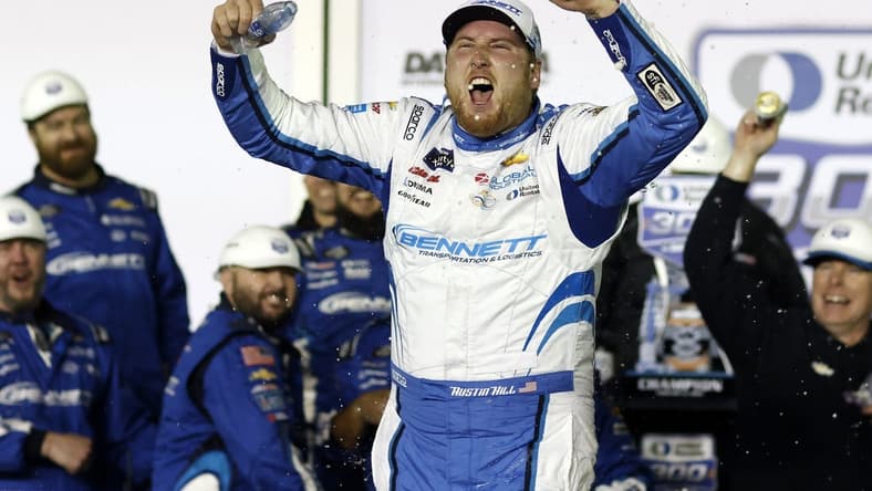 Feb 19, 2024; Daytona Beach, Florida, USA; Xfinity Series driver Austin Hill (21) reacts in victory lane after winning the United Rentals 300 at Daytona International Speedway. Mandatory Credit: Peter Casey-USA TODAY Sports