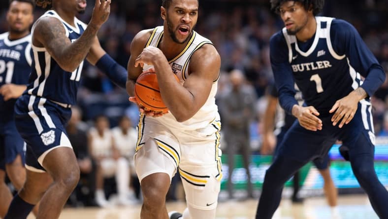 Feb 20, 2024; Villanova, Pennsylvania, USA; Villanova Wildcats forward Eric Dixon (43) controls the ball against Butler Bulldogs guard Jahmyl Telfort (11) and forward Jalen Thomas (1) during the second half at William B. Finneran Pavilion. Mandatory Credit: Bill Streicher-USA TODAY Sports