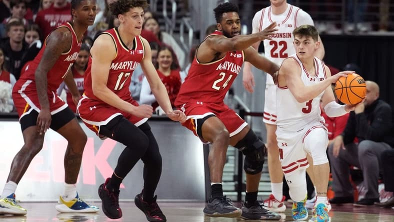 Feb 20, 2024; Madison, Wisconsin, USA; Wisconsin Badgers guard Connor Essegian (3) passes the ball against Maryland Terrapins forward Donta Scott (24) and Maryland Terrapins forward Jamie Kaiser Jr. (12) during the first half at the Kohl Center. Mandatory Credit: Kayla Wolf-USA TODAY Sports