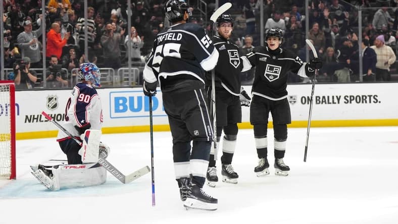 Feb 20, 2024; Los Angeles, California, USA; LA Kings center Pierre-Luc Dubois (80) celebrates after scoring a goal with right wing Quinton Byfield (55) and center Alex Turcotte (38) as Columbus Blue Jackets goaltender Elvis Merzlikins (90) reacts in the second period at Crypto.com Arena. Mandatory Credit: Kirby Lee-USA TODAY Sports