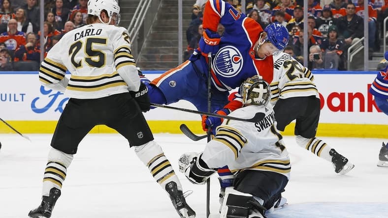 Feb 21, 2024; Edmonton, Alberta, CAN; Edmonton Oilers forward Warren Foegele (37) crashes into Boston Bruins goaltender Jeremy Swayman (1) during the first period at Rogers Place. Mandatory Credit: Perry Nelson-USA TODAY Sports