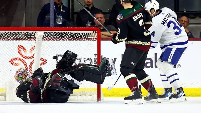 Feb 21, 2024; Tempe, Arizona, USA; Toronto Maple Leafs center Auston Matthews (34) scores a goal against Arizona Coyotes goaltender Karel Vejmelka (70) during the second period at Mullett Arena. Mandatory Credit: Mark J. Rebilas-USA TODAY Sports