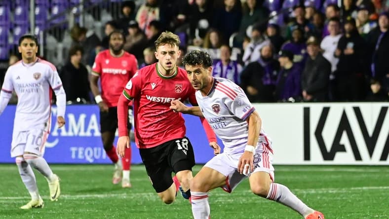 Feb 21, 2024; Langford, BC, Canada; Orlando City midfielder Felipe Martins (8) controls the ball against Cavalry FC midfielder Mael Henry (18) during the second half at Starlight Stadium. Mandatory Credit: Simon Fearn-USA TODAY Sports