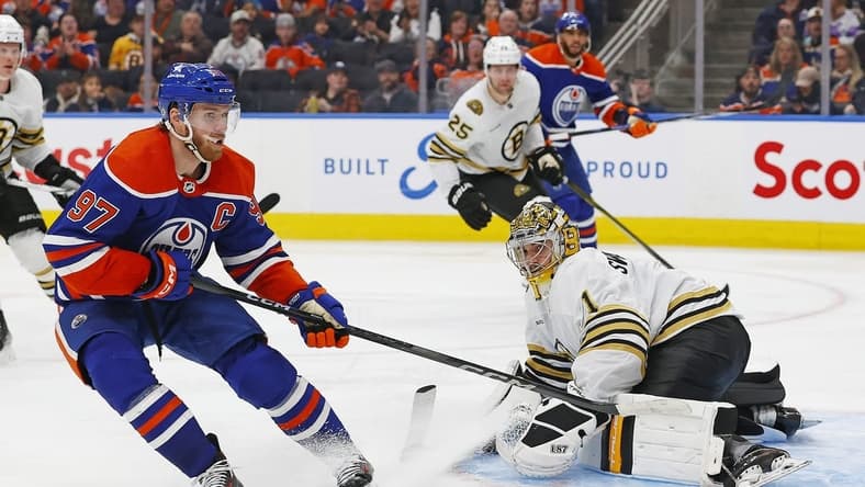Feb 21, 2024; Edmonton, Alberta, CAN; Boston Bruins goaltender Jeremy Swayman (1) makes a save on on Edmonton Oilers forward Connor McDavid (97) during the third period at Rogers Place. Mandatory Credit: Perry Nelson-USA TODAY Sports