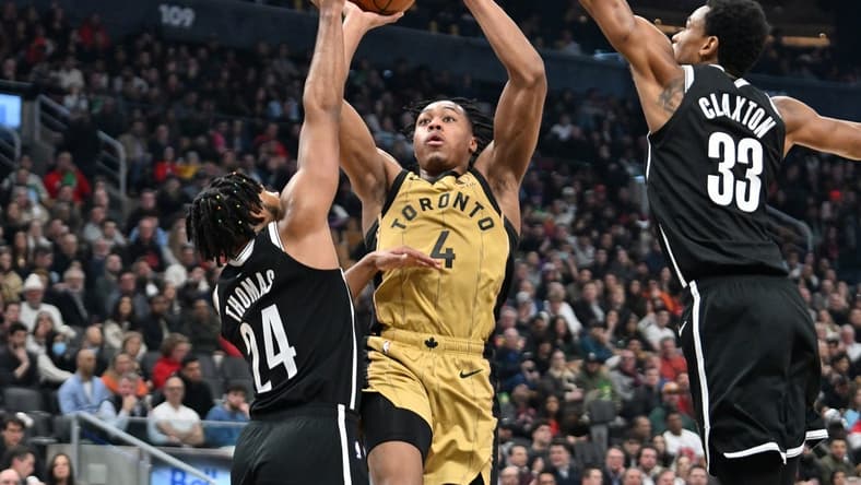 Feb 22, 2024; Toronto, Ontario, CAN; Toronto Raptors forward Scottie Barnes (4) shoots the ball as Brooklyn Nets guard Cam Thomas (24) and center Nic Claxton (33) defend in the first half at Scotiabank Arena. Mandatory Credit: Dan Hamilton-USA TODAY Sports