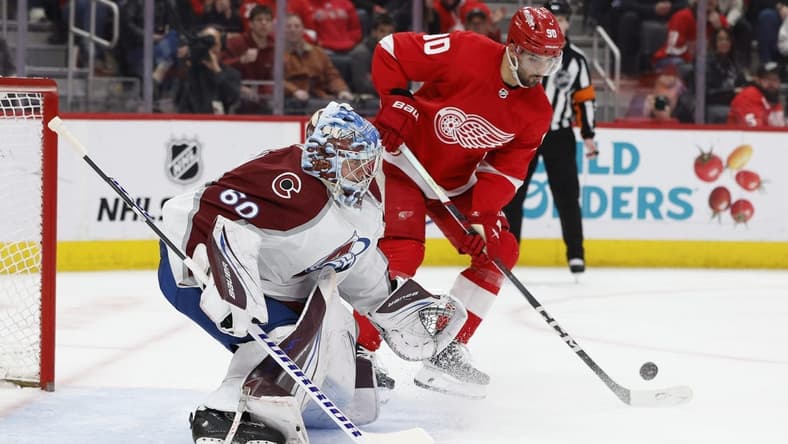 Feb 22, 2024; Detroit, Michigan, USA; Detroit Red Wings center Joe Veleno (90) tries to score on Colorado Avalanche goaltender Justus Annunen (60) in the second period at Little Caesars Arena. Mandatory Credit: Rick Osentoski-USA TODAY Sports