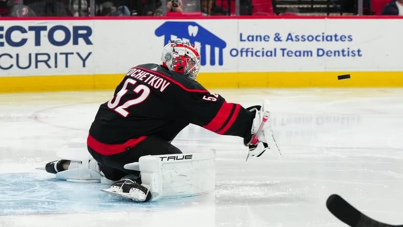 Feb 22, 2024; Raleigh, North Carolina, USA; Carolina Hurricanes goaltender Pyotr Kochetkov (52) makes a blocker save against the Florida Panthers during the second period at PNC Arena. Mandatory Credit: James Guillory-USA TODAY Sports