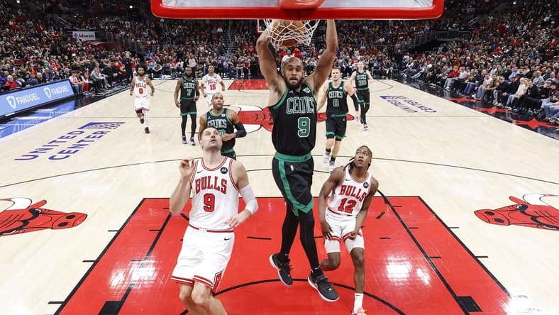 Feb 22, 2024; Chicago, Illinois, USA; Boston Celtics guard Derrick White (9) dunks the ball against the Chicago Bulls during the first half at United Center. Mandatory Credit: Kamil Krzaczynski-USA TODAY Sports