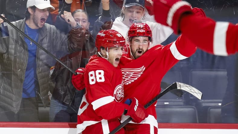 Feb 22, 2024; Detroit, Michigan, USA; Detroit Red Wings right wing Patrick Kane (88) receives congratulations from center Dylan Larkin (71) after scoring in overtime against the Colorado Avalanche at Little Caesars Arena. Mandatory Credit: Rick Osentoski-USA TODAY Sports