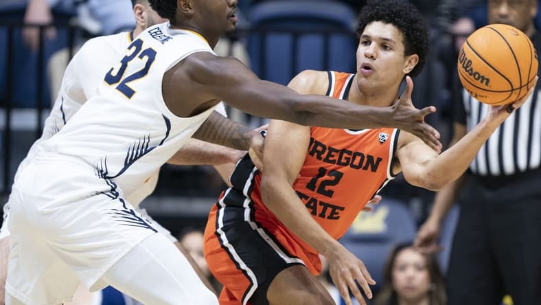 February 22, 2024; Berkeley, California, USA; Oregon State Beavers forward Michael Rataj (12) passes the basketball against California Golden Bears guard Jalen Celestine (32) during the first half at Haas Pavilion. Mandatory Credit: Kyle Terada-USA TODAY Sports