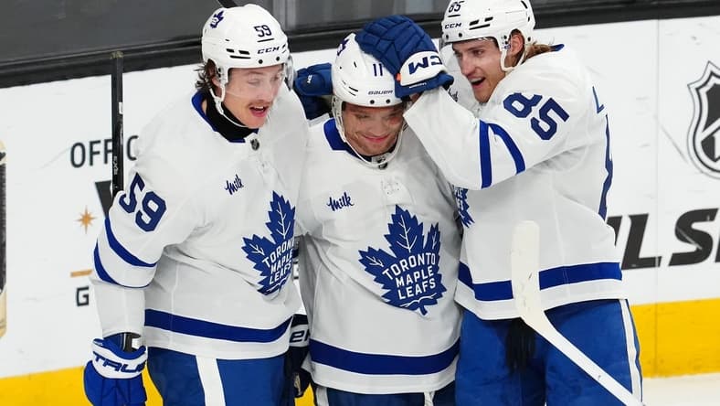 Feb 22, 2024; Las Vegas, Nevada, USA; Toronto Maple Leafs center Max Domi (11) celebrates with left wing Tyler Bertuzzi (59) and defenseman William Lagesson (85) after scoring a goal against the Vegas Golden Knights during the first period at T-Mobile Arena. Mandatory Credit: Stephen R. Sylvanie-USA TODAY Sports