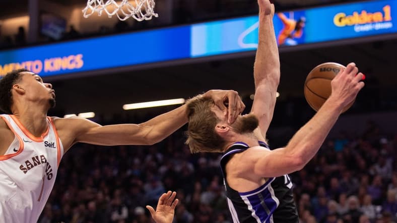 Feb 22, 2024; Sacramento, California, USA; Sacramento Kings forward Domantas Sabonis (10) is fouled by San Antonio Spurs center Victor Wembanyama (1) during the second quarter at Golden 1 Center. Mandatory Credit: Ed Szczepanski-USA TODAY Sports