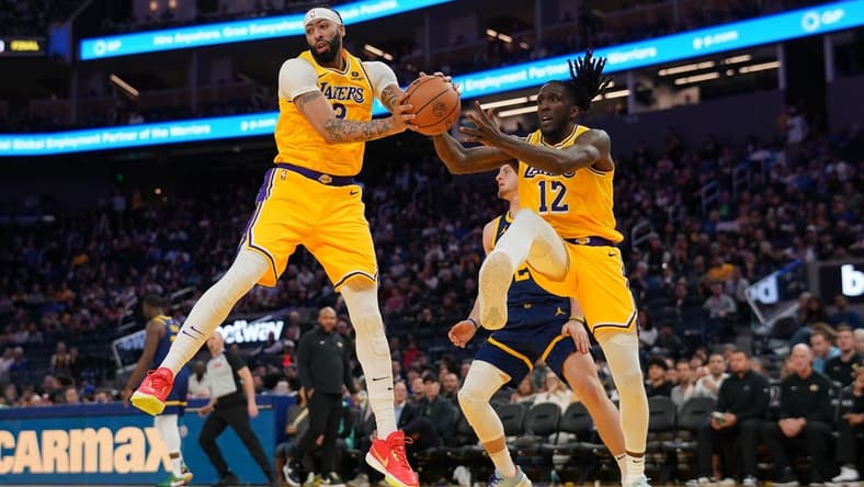Feb 22, 2024; San Francisco, California, USA; Los Angeles Lakers forward Anthony Davis (3) holds onto a rebound next to forward Taurean Prince (12) against the Golden State Warriors in the third quarter at the Chase Center. Mandatory Credit: Cary Edmondson-USA TODAY Sports