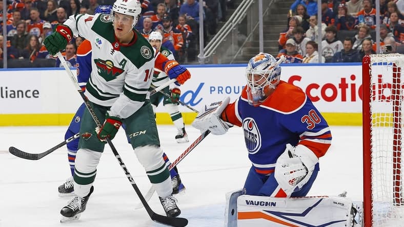 Feb 23, 2024; Edmonton, Alberta, CAN; Minnesota Wild forward Joel Ericksson EK (14) looks for a deletion in front of Edmonton Oilers goaltender Calvin Pickard (30) during the second period at Rogers Place. Mandatory Credit: Perry Nelson-USA TODAY Sports
