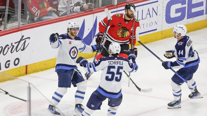 Feb 23, 2024; Chicago, Illinois, USA; Winnipeg Jets left wing Kyle Connor (81) celebrates with teammates after scoring a game winning goal against the Chicago Blackhawks during overtime at United Center. Mandatory Credit: Kamil Krzaczynski-USA TODAY Sports