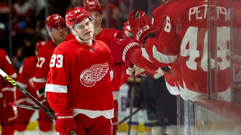 Feb 24, 2024; Detroit, Michigan, USA;  Detroit Red Wings right wing Alex DeBrincat (93) receives congratulations from teammates after scoring in the first period against the St. Louis Blues at Little Caesars Arena. Mandatory Credit: Rick Osentoski-USA TODAY Sports