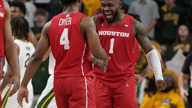 Feb 24, 2024; Waco, Texas, USA; Houston Cougars guard L.J. Cryer (4) and guard Jamal Shead (1) react in the closing moments of overtime against the Baylor Bears at Paul and Alejandra Foster Pavilion. Mandatory Credit: Raymond Carlin III-USA TODAY Sports