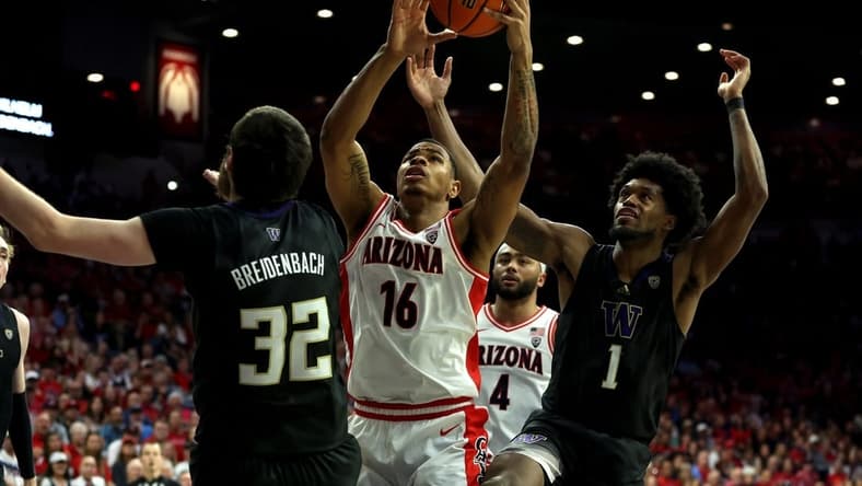 Feb 24, 2024; Tucson, Arizona, USA; Arizona Wildcats forward Keshad Johnson (16) gets a rebound against Washington Huskies forward Wilhelm Breidenbach (32) and forward Keion Brooks Jr. (1) during the second half at McKale Center. Mandatory Credit: Zachary BonDurant-USA TODAY Sports