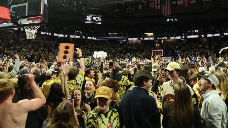 Feb 24, 2024; Winston-Salem, North Carolina, USA; Wake Forest Demon Deacons students storm the court after Wake Forest wins at Lawrence Joel Veterans Memorial Coliseum. Mandatory Credit: Cory Knowlton-USA TODAY Sports