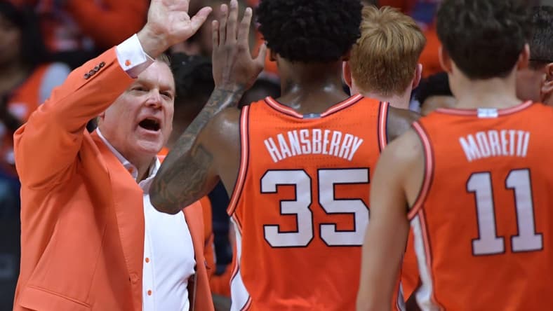 Feb 24, 2024; Champaign, Illinois, USA; Illinois Fighting Illini head coach Brad Underwood gives players a hand during the second half against the Iowa Hawkeyes at State Farm Center. Mandatory Credit: Ron Johnson-USA TODAY Sports