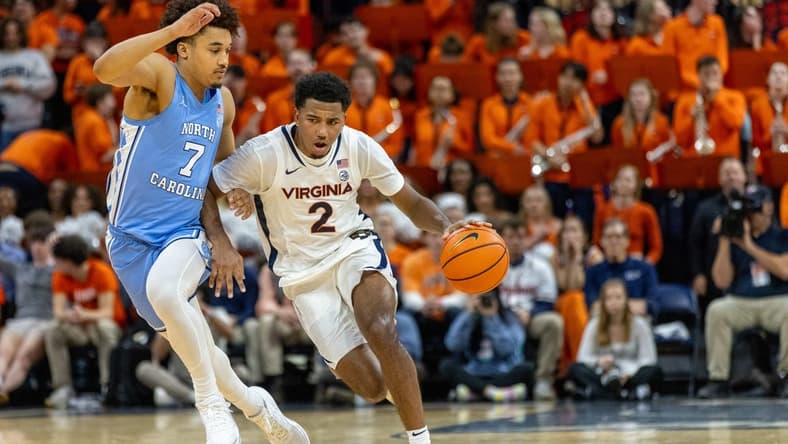 Feb 24, 2024; Charlottesville, Virginia, USA; Virginia Cavaliers guard Reece Beekman (2) drives to the basket while North Carolina Tar Heels guard Seth Trimble (7) defends during the second half at John Paul Jones Arena. Mandatory Credit: Hannah Pajewski-USA TODAY Sports