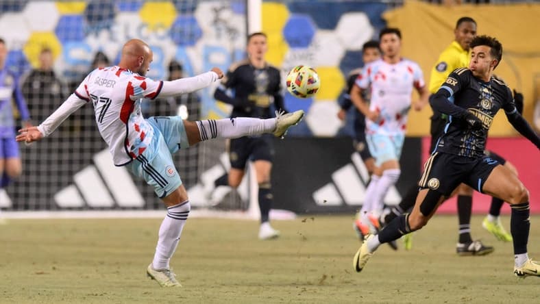 Feb 24, 2024; Philadelphia, Pennsylvania, USA; Chicago Fire FC defender Chase Gasper (77) kicks the ball against the Philadelphia Union during the first half at Subaru Park. Mandatory Credit: John Jones-USA TODAY Sports