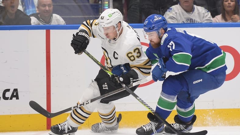 Feb 24, 2024; Vancouver, British Columbia, CAN;  Vancouver Canucks defenseman Filip Hronek (17) checks Boston Bruins forward Brad Marchand (63) during the second period at Rogers Arena. Mandatory Credit: Anne-Marie Sorvin-USA TODAY Sports