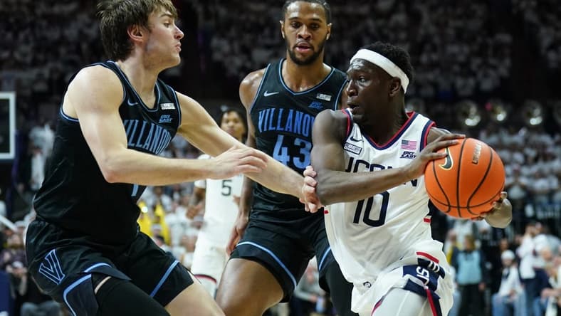 Feb 24, 2024; Storrs, Connecticut, USA; UConn Huskies guard Hassan Diarra (10) drives the ball against Villanova Wildcats forward Eric Dixon (43) and guard Brendan Hausen (1) in the second half at Harry A. Gampel Pavilion. Mandatory Credit: David Butler II-USA TODAY Sports