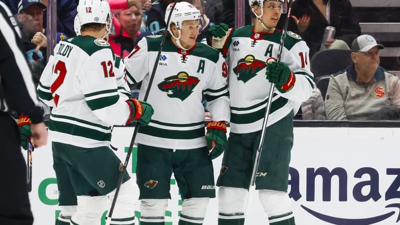Feb 24, 2024; Seattle, Washington, USA; Minnesota Wild left wing Kirill Kaprizov (97) celebrates with center Joel Eriksson Ek (14) after scoring a goal against the Seattle Kraken during the first period at Climate Pledge Arena. Mandatory Credit: Joe Nicholson-USA TODAY Sports