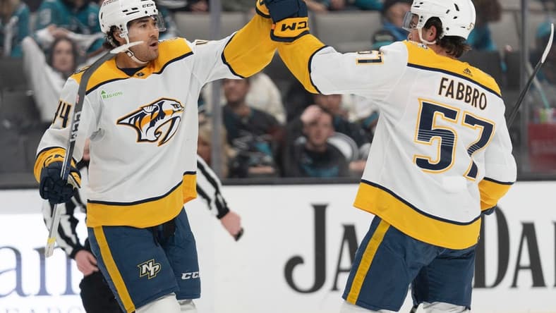 Feb 24, 2024; San Jose, California, USA; Nashville Predators left wing Kiefer Sherwood (44) celebrates with defenseman Dante Fabbro (57) after scoring a goal during the first period against the San Jose Sharks at SAP Center at San Jose. Mandatory Credit: Stan Szeto-USA TODAY Sports