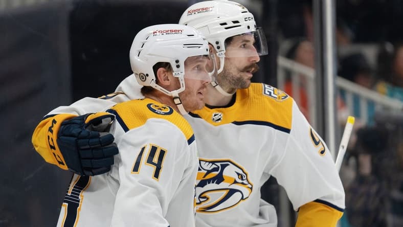 Feb 24, 2024; San Jose, California, USA; Nashville Predators left wing Filip Forsberg (9) hugs center Gustav Nyquist (14) after scoring a goal during the third period against the San Jose Sharks at SAP Center at San Jose. Mandatory Credit: Stan Szeto-USA TODAY Sports