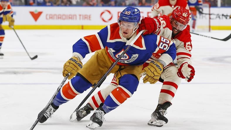 Feb 24, 2024; Edmonton, Alberta, CAN; Edmonton Oilers. forward Dylan Holloway (55) carries the puck around Calgary Flames defensemen Oliver Kylington (58) during the third period at Rogers Place. Mandatory Credit: Perry Nelson-USA TODAY Sports