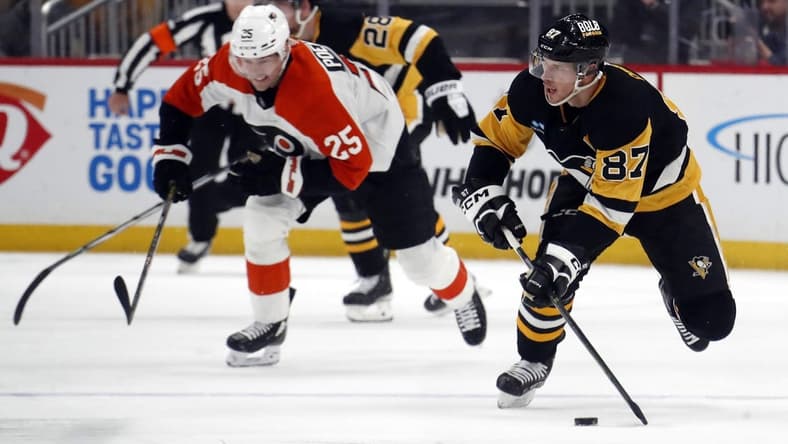 Feb 25, 2024; Pittsburgh, Pennsylvania, USA;  Pittsburgh Penguins center Sidney Crosby (87) controls the puck against the Philadelphia Flyers during the second period at PPG Paints Arena. Mandatory Credit: Charles LeClaire-USA TODAY Sports