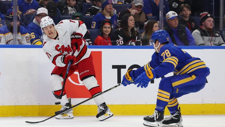 Feb 25, 2024; Buffalo, New York, USA;  Buffalo Sabres defenseman Jacob Bryson (78) tries to block a pass by Carolina Hurricanes right wing Jesper Fast (71) during the first period at KeyBank Center. Mandatory Credit: Timothy T. Ludwig-USA TODAY Sports