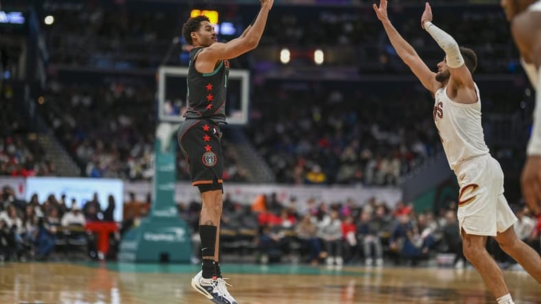 Feb 25, 2024; Washington, District of Columbia, USA; Washington Wizards guard Jordan Poole (13) shoots over Cleveland Cavaliers forward Georges Niang (20) during the second half at Capital One Arena. Mandatory Credit: Tommy Gilligan-USA TODAY Sports