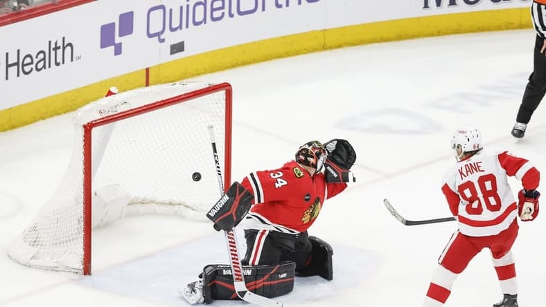 Feb 25, 2024; Chicago, Illinois, USA; Detroit Red Wings right wing Patrick Kane (88) scores game winning goal against Chicago Blackhawks goaltender Petr Mrazek (34) in overtime at United Center. Mandatory Credit: Kamil Krzaczynski-USA TODAY Sports