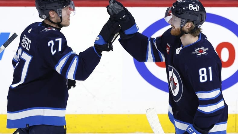 Feb 25, 2024; Winnipeg, Manitoba, CAN; Winnipeg Jets left wing Kyle Connor (81) celebrates his overtime goal with Winnipeg Jets left wing Nikolaj Ehlers (27) against the Arizona Coyotes at Canada Life Centre. Mandatory Credit: James Carey Lauder-USA TODAY Sports