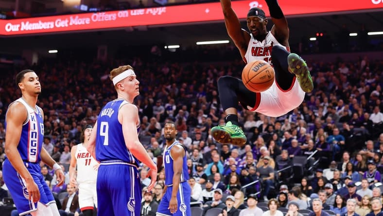 Feb 26, 2024; Sacramento, California, USA; Miami Heat center Bam Adebayo (13) dunks the ball against Sacramento Kings guard Kevin Huerter (9) during the first quarter at Golden 1 Center. Mandatory Credit: Sergio Estrada-USA TODAY Sports