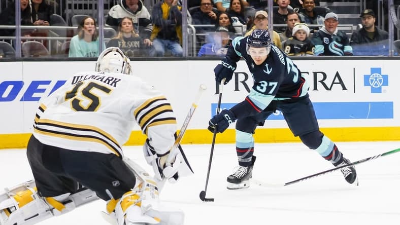 Feb 26, 2024; Seattle, Washington, USA; Seattle Kraken center Yanni Gourde (37) skates with the puck against the Boston Bruins during the first period at Climate Pledge Arena. Mandatory Credit: Joe Nicholson-USA TODAY Sports