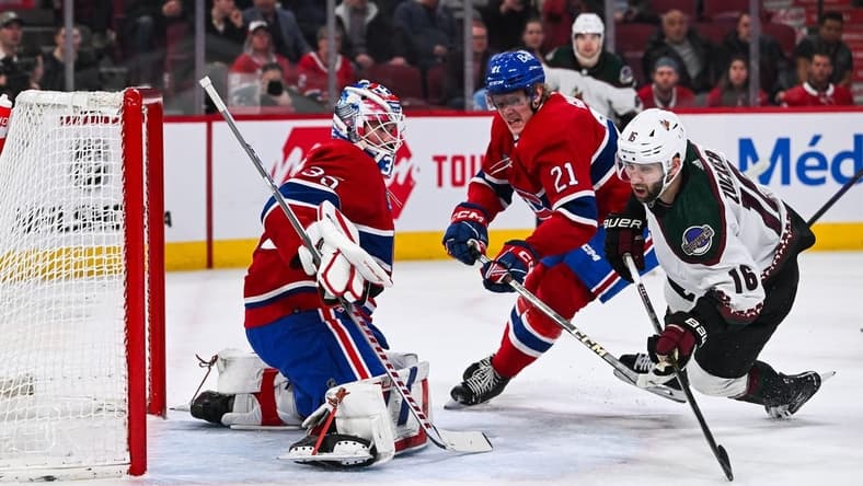Feb 27, 2024; Montreal, Quebec, CAN; Montreal Canadiens goalie Sam Montembeault (35) makes a save against Arizona Coyotes left wing Jason Zucker (16) during the first period at Bell Centre. Mandatory Credit: David Kirouac-USA TODAY Sports