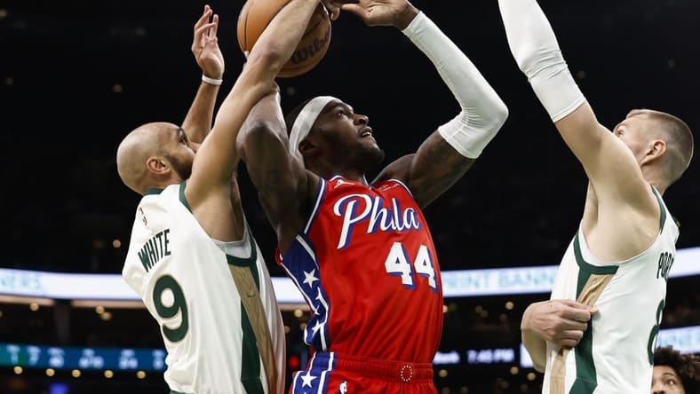 Feb 27, 2024; Boston, Massachusetts, USA; Boston Celtics guard Derrick White (9) knocks the ball away from Philadelphia 76ers forward Paul Reed (44) as he goes for a shot during the first quarter at TD Garden. Mandatory Credit: Winslow Townson-USA TODAY Sports